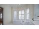 Relaxing bathroom featuring a soaking tub, bright windows, and white tile for a spa-like experience at 111 Dixson Rd, Bowdon, GA 30108