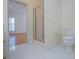 Well-lit bathroom with white tile floor and glass-enclosed shower at 111 Dixson Rd, Bowdon, GA 30108