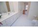 Bright bathroom with vanity, white cabinets, tile floor and ensuite access at 111 Dixson Rd, Bowdon, GA 30108