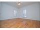 Bedroom features wood flooring, large windows, ceiling fan, and neutral paint at 111 Dixson Rd, Bowdon, GA 30108