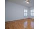 Large bedroom with light hardwood floors and white walls and trim with ceiling fan at 111 Dixson Rd, Bowdon, GA 30108