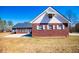 Brick house featuring a well-manicured lawn and a two-car garage showcasing curb appeal at 111 Dixson Rd, Bowdon, GA 30108