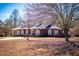 Captivating brick home with dormer windows, a covered porch, and a meticulously maintained front yard at 111 Dixson Rd, Bowdon, GA 30108