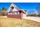 A red-brick house with a two-car garage, a white awning, and a well-maintained front yard at 111 Dixson Rd, Bowdon, GA 30108