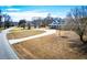 A serene view of a charming brick home with a long, curved driveway and spacious front yard at 111 Dixson Rd, Bowdon, GA 30108