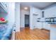 The kitchen has light, hardwood floors, white cabinetry and granite countertops at 111 Dixson Rd, Bowdon, GA 30108