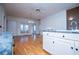 Bright living room with hardwood floors, white trim, and view into an adjacent sunroom at 111 Dixson Rd, Bowdon, GA 30108