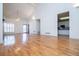 Open-concept living area featuring high ceilings, hardwood floors, and access to the kitchen at 111 Dixson Rd, Bowdon, GA 30108