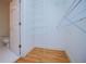 Walk-in closet with shelves and hardwood floors plus ensuite bathroom access at 111 Dixson Rd, Bowdon, GA 30108