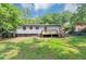 Spacious backyard with lush lawn, wooden deck, and mature trees at 2317 Baywood Se Dr, Atlanta, GA 30315