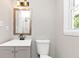 Bright bathroom featuring a vanity with a framed mirror, modern fixtures, and tiled shower at 2317 Baywood Se Dr, Atlanta, GA 30315