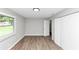 Bright bedroom with light wood floors, neutral walls, and a closet with sliding doors at 2317 Baywood Se Dr, Atlanta, GA 30315