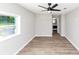 Bright bedroom features wood-look floors, a ceiling fan, window, and attached bathroom at 2317 Baywood Se Dr, Atlanta, GA 30315