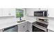 Bright kitchen with stainless steel appliances, gray lower cabinets, and white countertops at 2317 Baywood Se Dr, Atlanta, GA 30315