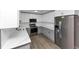Well-appointed kitchen featuring stainless steel appliances, white upper cabinets, and gray lower cabinets at 2317 Baywood Se Dr, Atlanta, GA 30315