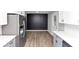 Modern kitchen with stainless steel refrigerator, gray lower cabinets, and designer wall at 2317 Baywood Se Dr, Atlanta, GA 30315