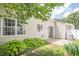 Landscaped backyard boasts a sliding glass door and green foliage to provide shade and privacy at 331 Windcroft Nw Ln, Acworth, GA 30101
