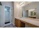 A bright bathroom features a large mirror, vanity with storage, and a shower-tub combo at 331 Windcroft Nw Ln, Acworth, GA 30101