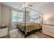 A light-filled bedroom with ceiling fan, unique celestial decor, and a charming canopy bed at 331 Windcroft Nw Ln, Acworth, GA 30101