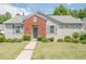 Charming single-story home with manicured lawn, sidewalk and gray vinyl siding with red brick accent at 331 Windcroft Nw Ln, Acworth, GA 30101