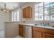 A compact kitchen with stainless steel dishwasher and wooden cabinetry near a sliding door at 331 Windcroft Nw Ln, Acworth, GA 30101