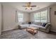 Cozy living room with large window, sectional sofa, ceiling fan, and neutral carpet at 331 Windcroft Nw Ln, Acworth, GA 30101