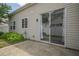 View of the back patio with sliding glass door and green foliage around the house at 331 Windcroft Nw Ln, Acworth, GA 30101