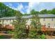 Back view of townhomes reveals spacious wooden decks and grassy yards surrounded by mature trees at 3692 Lambert Ne Ln, Brookhaven, GA 30319