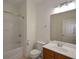 This is a bathroom with a shower and tub combo plus a cherry wood cabinet beneath the sink at 3692 Lambert Ne Ln, Brookhaven, GA 30319