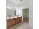 Bathroom with double vanity, tile floor, mirror, and an open walk-in closet at 3692 Lambert Ne Ln, Brookhaven, GA 30319