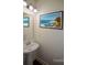 Bathroom with a pedestal sink and seascape artwork that is virtually staged at 3692 Lambert Ne Ln, Brookhaven, GA 30319