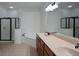 Modern bathroom with double sinks, wood cabinets, and a separate glass-enclosed shower for a spa-like experience at 3692 Lambert Ne Ln, Brookhaven, GA 30319