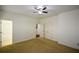 A carpeted bedroom with an attached bathroom and double-door closet allows for flexible storage options at 3692 Lambert Ne Ln, Brookhaven, GA 30319