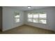 Well-lit bedroom featuring large windows, neutral carpeting, and ample natural light, perfect for relaxation at 3692 Lambert Ne Ln, Brookhaven, GA 30319