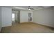 Large bedroom featuring neutral carpet, ample space, and multiple doorways for easy access throughout the house at 3692 Lambert Ne Ln, Brookhaven, GA 30319