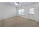 Empty bedroom with carpet, ceiling fan and white walls at 3692 Lambert Ne Ln, Brookhaven, GA 30319