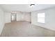 Large bedroom with carpet flooring, a tray ceiling, and natural light at 3692 Lambert Ne Ln, Brookhaven, GA 30319