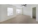 Bright bedroom with carpet, a ceiling fan, and an open closet at 3692 Lambert Ne Ln, Brookhaven, GA 30319
