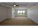 Large bedroom features carpeted flooring, tray ceiling, and natural light from windows at 3692 Lambert Ne Ln, Brookhaven, GA 30319