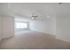 Large bedroom featuring a tray ceiling, carpet flooring, and plenty of natural light at 3692 Lambert Ne Ln, Brookhaven, GA 30319