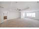 Large bedroom with tray ceilings, carpet, and large windows providing natural light at 3692 Lambert Ne Ln, Brookhaven, GA 30319