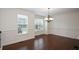 Formal dining room with hardwood floors, wainscoting, and ample natural light from large windows at 3692 Lambert Ne Ln, Brookhaven, GA 30319
