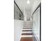 Welcoming entryway with hardwood floors, white walls, and wrought iron railing leading to the upper level at 3692 Lambert Ne Ln, Brookhaven, GA 30319