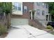Attractive townhome with brick and siding exterior, featuring a two-car garage and well-maintained landscaping at 3692 Lambert Ne Ln, Brookhaven, GA 30319