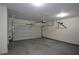 Empty two car garage with white walls and ceiling plus concrete flooring at 3692 Lambert Ne Ln, Brookhaven, GA 30319