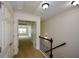 Hallway with staircase features carpeted flooring, closet space, and an open doorway at 3692 Lambert Ne Ln, Brookhaven, GA 30319