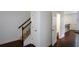 Hallway with staircase and closet features hardwood floors leading to a bathroom at 3692 Lambert Ne Ln, Brookhaven, GA 30319