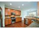 Modern kitchen featuring stainless steel appliances, wood cabinets, and granite countertops at 3692 Lambert Ne Ln, Brookhaven, GA 30319
