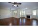 Open living room features hardwood floors, fireplace, and access to outdoor space at 3692 Lambert Ne Ln, Brookhaven, GA 30319