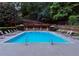 Relaxing community pool with lounge chairs and shaded seating areas for residents to enjoy on warm days at 3692 Lambert Ne Ln, Brookhaven, GA 30319